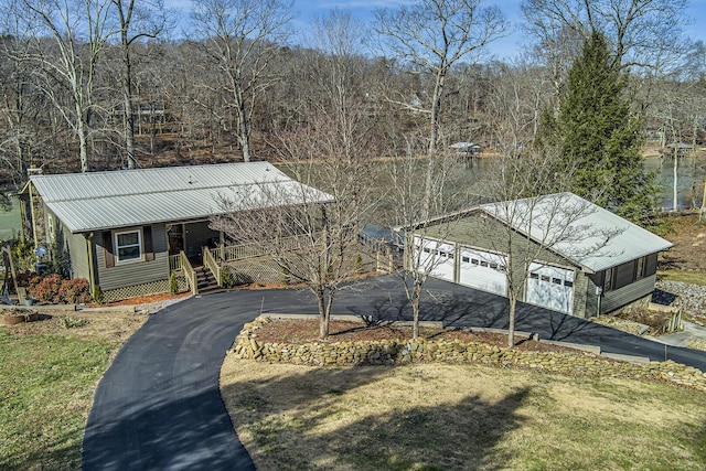 view of front of property with a porch, a garage, and a front yard