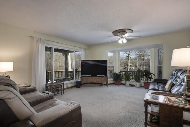 living room featuring ceiling fan and carpet