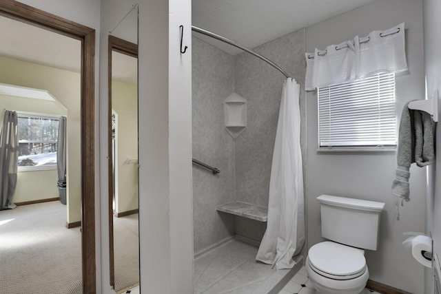 bathroom featuring toilet and a shower with curtain