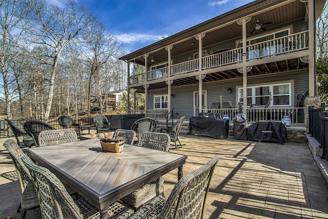 deck with ceiling fan, grilling area, a hot tub, and a patio