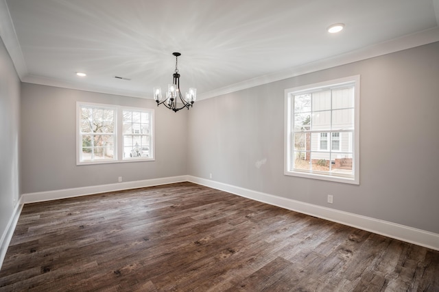 unfurnished room with dark hardwood / wood-style flooring, crown molding, and an inviting chandelier