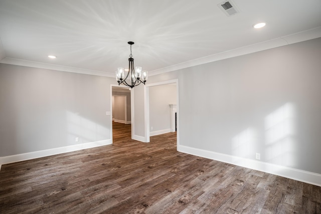 unfurnished dining area featuring crown molding, dark hardwood / wood-style flooring, and an inviting chandelier