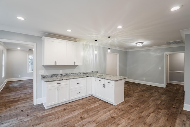 kitchen with white cabinets, dark hardwood / wood-style floors, decorative light fixtures, light stone counters, and kitchen peninsula