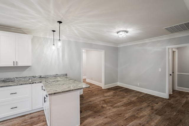 kitchen featuring white cabinetry, hanging light fixtures, light stone counters, and ornamental molding