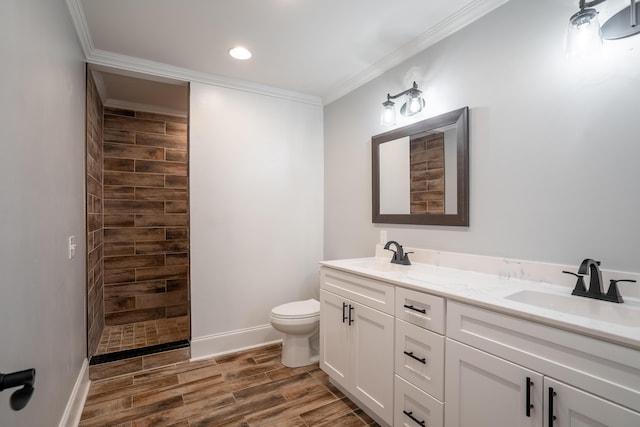 bathroom featuring a shower, crown molding, vanity, and toilet