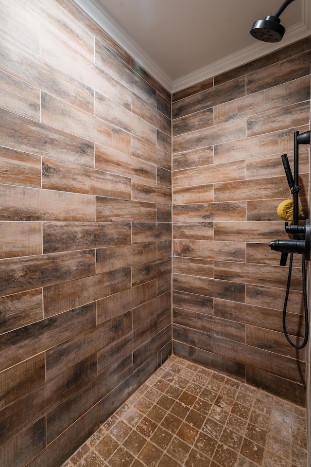 bathroom featuring tiled shower and ornamental molding