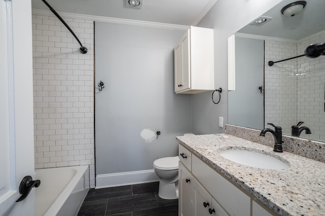 full bathroom with tiled shower / bath, toilet, vanity, and ornamental molding