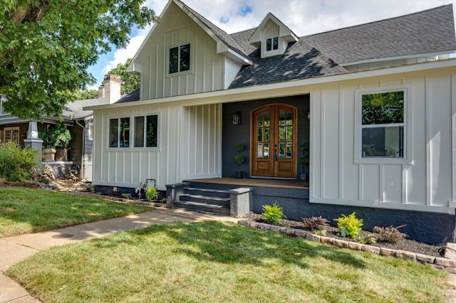 view of front of home featuring a front lawn and french doors