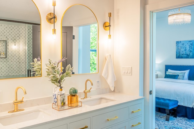 bathroom with vanity and a chandelier