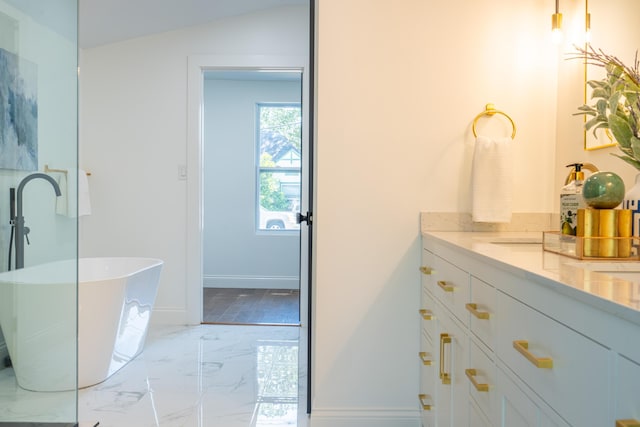 bathroom featuring a bathing tub and vanity