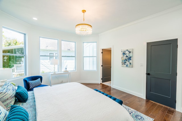 bedroom with dark hardwood / wood-style flooring, crown molding, and a chandelier