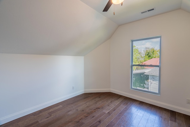 additional living space with a wealth of natural light, dark wood-type flooring, and lofted ceiling