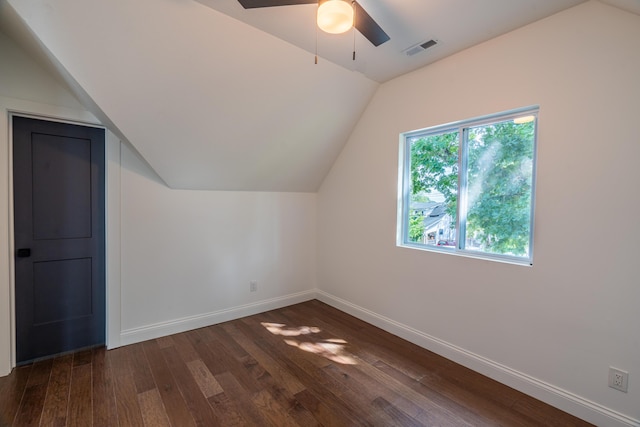 additional living space with dark hardwood / wood-style floors, vaulted ceiling, and ceiling fan