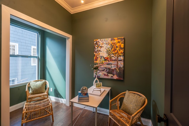 living area featuring crown molding and dark hardwood / wood-style floors