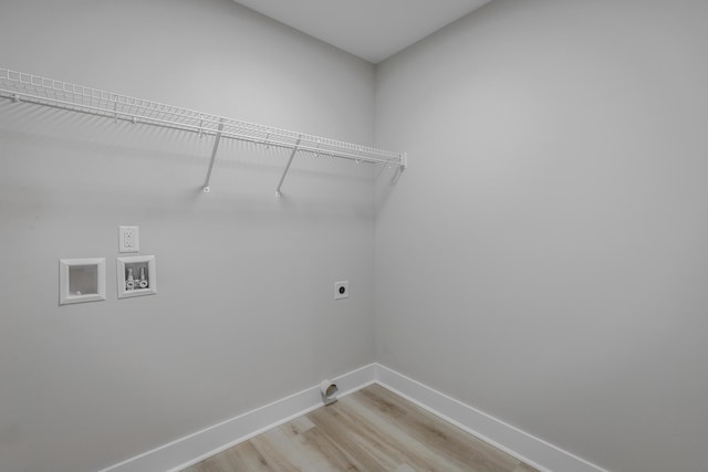 clothes washing area featuring washer hookup, light wood-type flooring, and hookup for an electric dryer