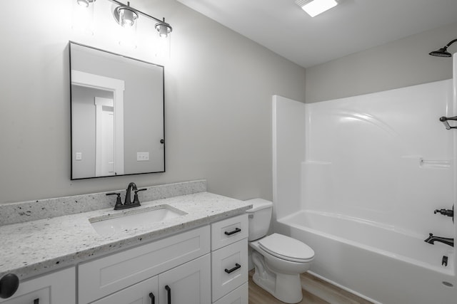 full bathroom featuring hardwood / wood-style flooring, vanity, shower / bathtub combination, and toilet