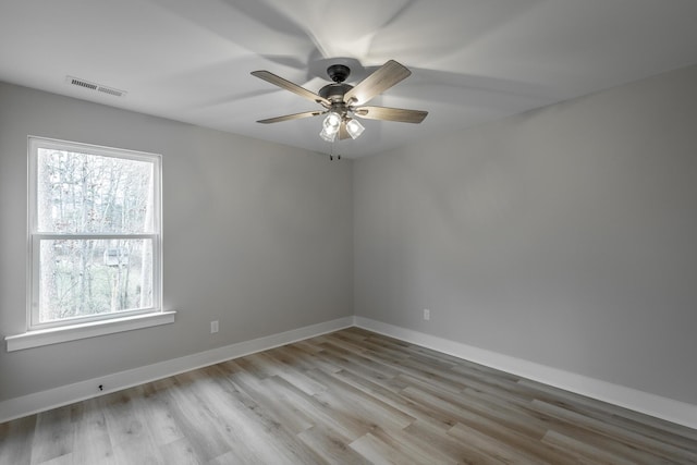 empty room with ceiling fan and light wood-type flooring