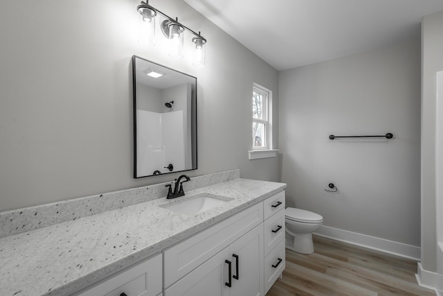 bathroom featuring a shower, vanity, wood-type flooring, and toilet