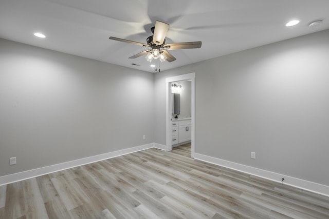 unfurnished room with light wood-type flooring, ceiling fan, and sink