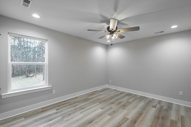 unfurnished room with light hardwood / wood-style flooring, a wealth of natural light, and ceiling fan