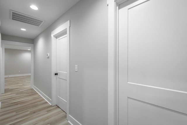 hallway with light hardwood / wood-style flooring