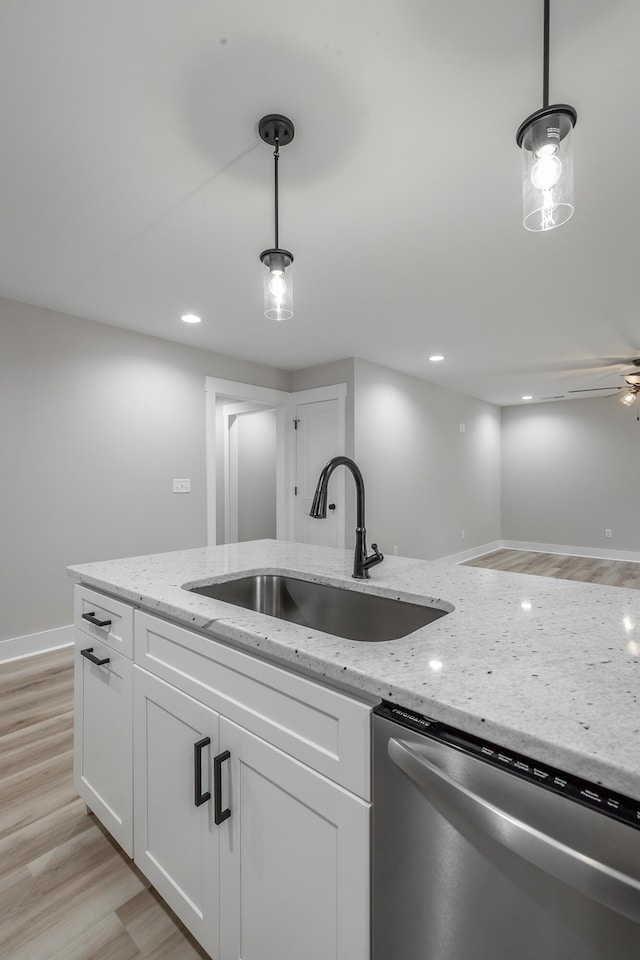 kitchen with white cabinets, dishwasher, sink, and hanging light fixtures