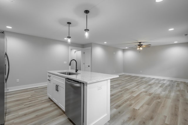 kitchen with sink, hanging light fixtures, an island with sink, white cabinets, and appliances with stainless steel finishes