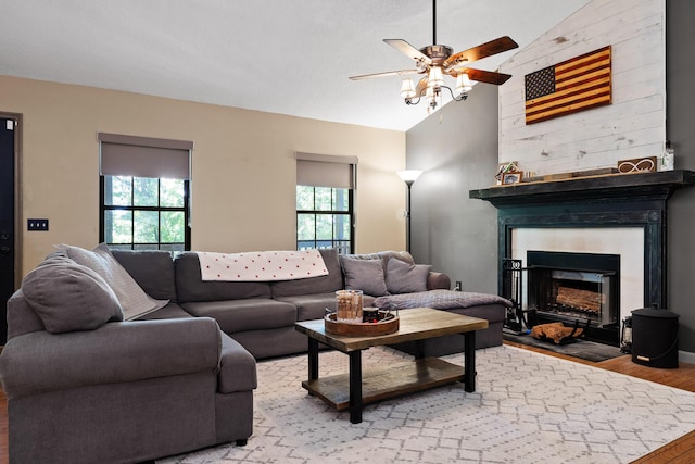 living room featuring light wood-type flooring, vaulted ceiling, plenty of natural light, and ceiling fan