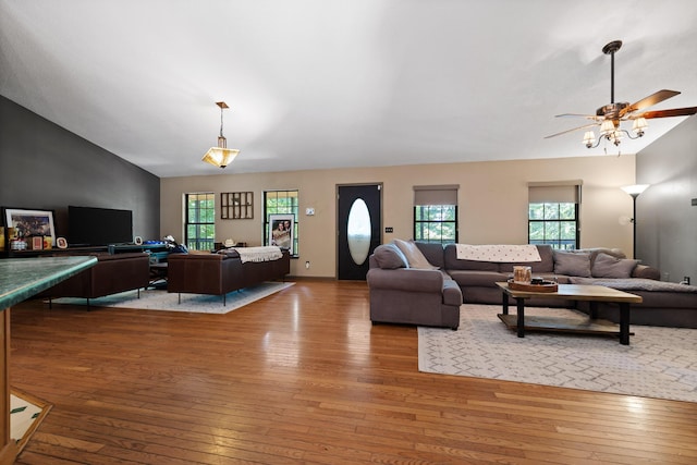 living room with ceiling fan, lofted ceiling, and light wood-type flooring