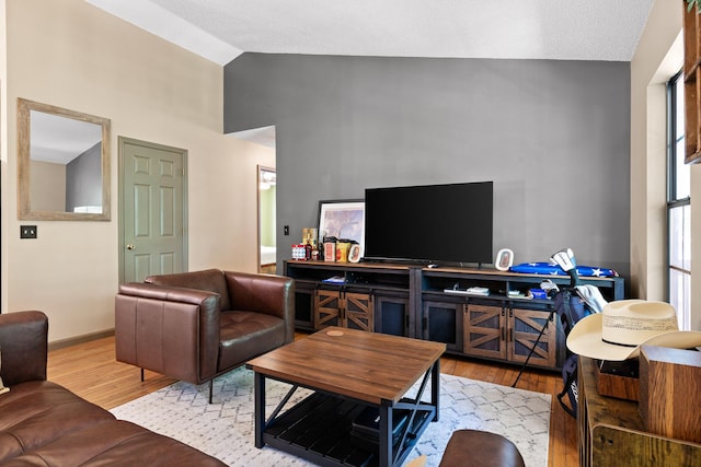 living room featuring light hardwood / wood-style flooring and lofted ceiling