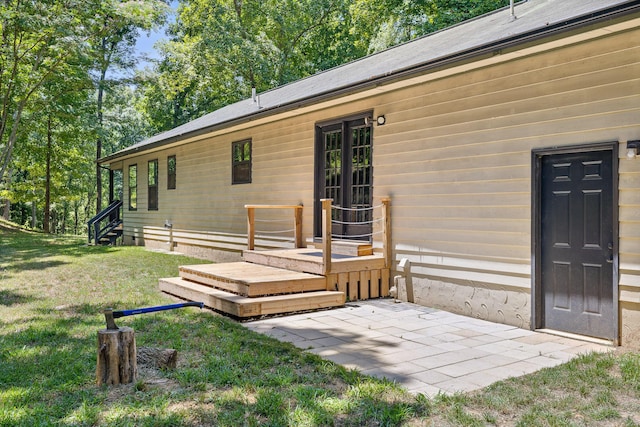 exterior space with a deck and a lawn