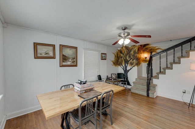 dining room with hardwood / wood-style floors, ceiling fan, and crown molding