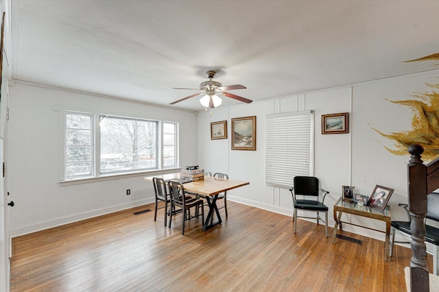 dining room with ceiling fan, ornamental molding, and light hardwood / wood-style flooring