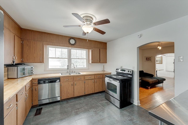 kitchen with stainless steel appliances, ceiling fan, and sink