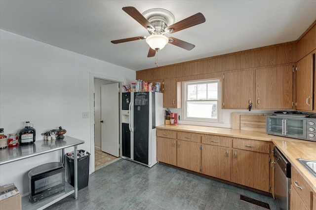 kitchen featuring fridge with ice dispenser, ceiling fan, and stainless steel dishwasher