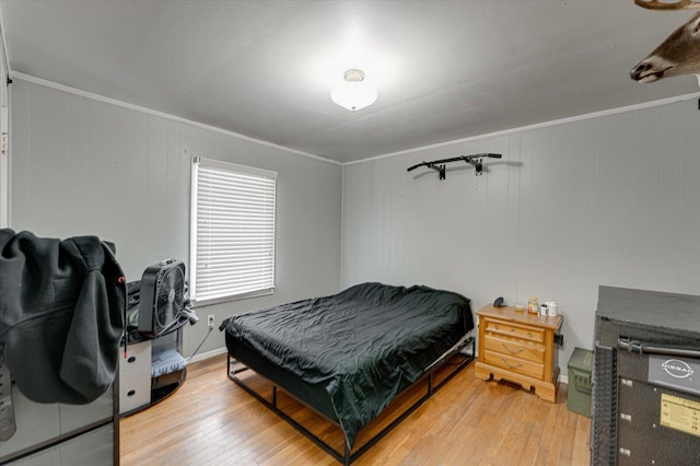 bedroom featuring light hardwood / wood-style floors and ornamental molding