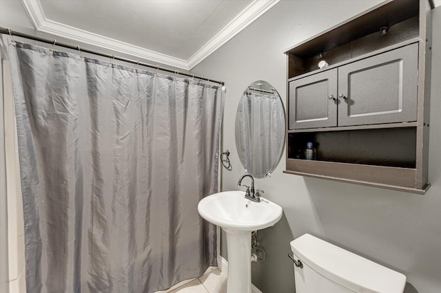 bathroom with toilet and crown molding