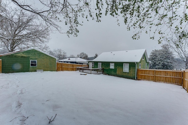 view of snow covered back of property