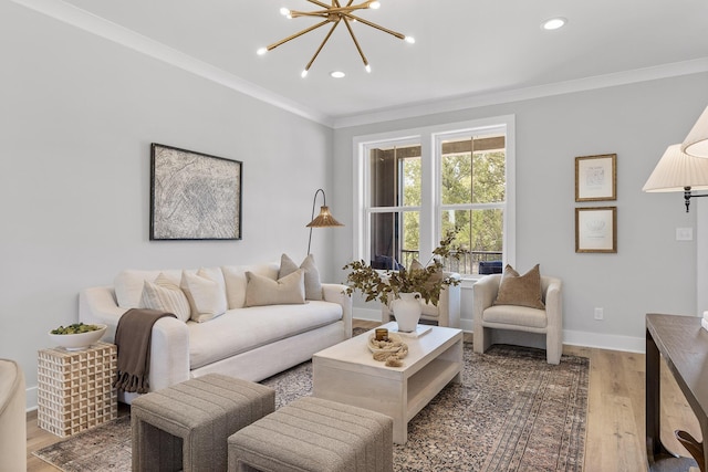 living room with hardwood / wood-style floors, ornamental molding, and a chandelier