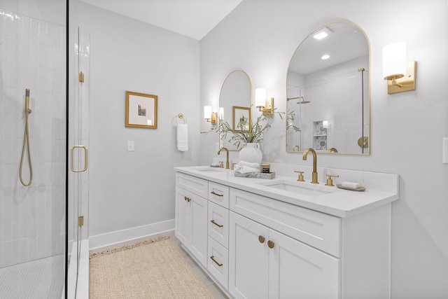 bathroom featuring a shower with door and vanity