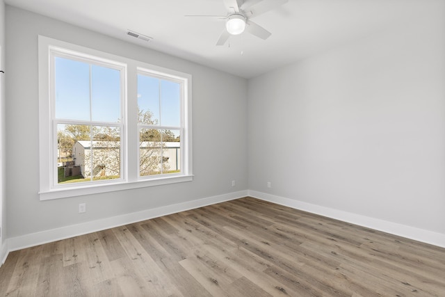 spare room featuring ceiling fan and light hardwood / wood-style floors