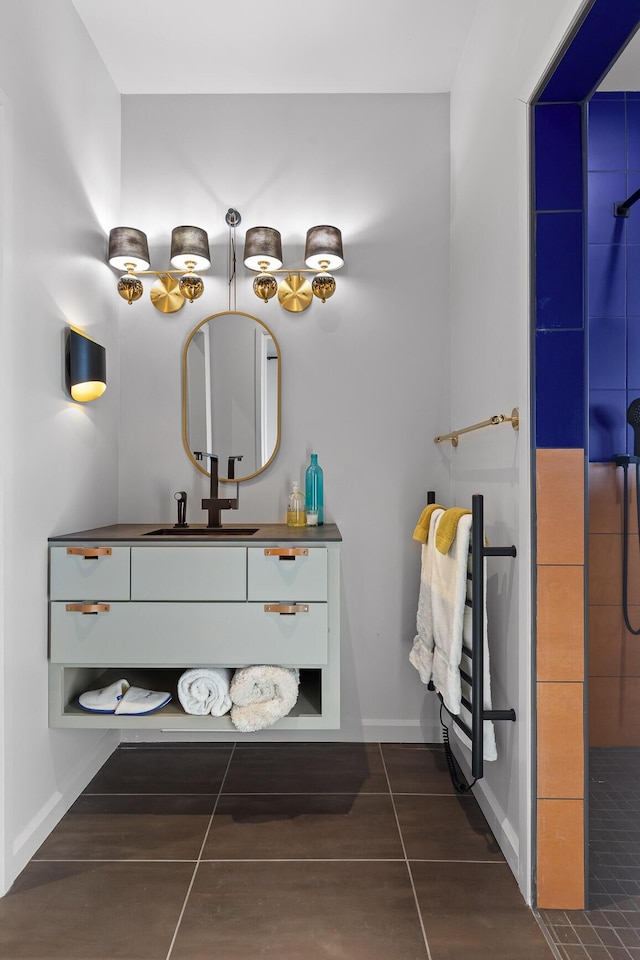 bathroom with walk in shower, vanity, and tile patterned flooring