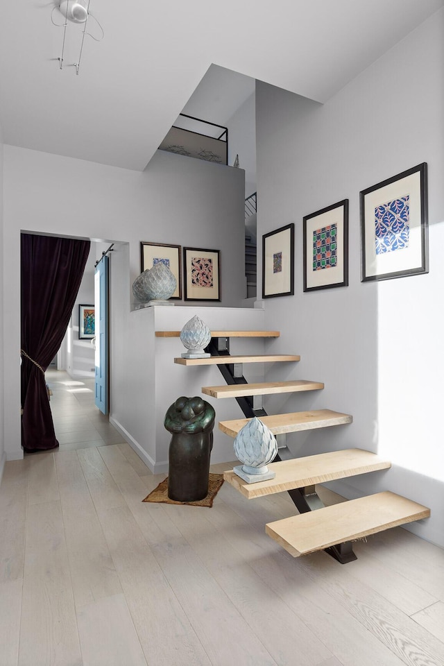 stairway featuring hardwood / wood-style flooring