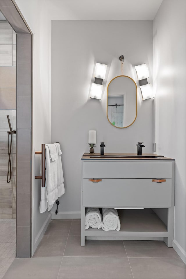 bathroom featuring vanity, tile patterned floors, and a tile shower