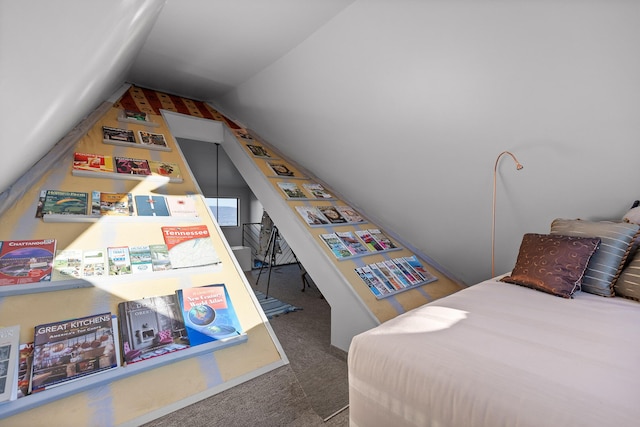 bedroom with vaulted ceiling and dark colored carpet