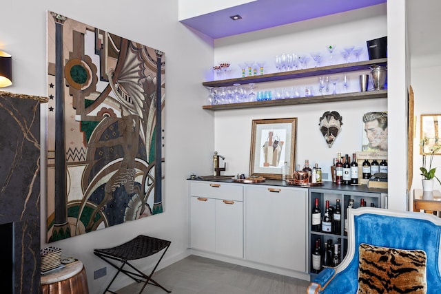 bar featuring sink and white cabinetry