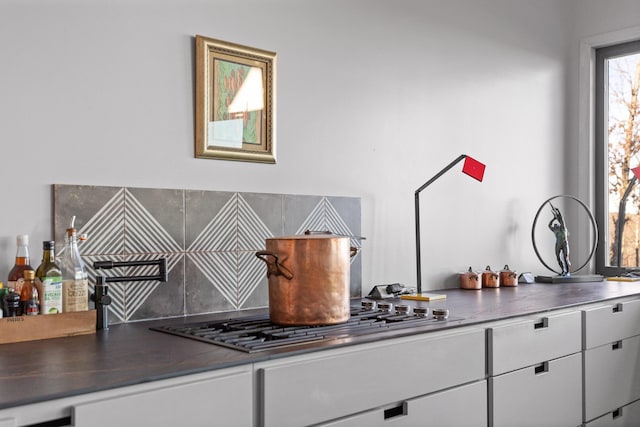 interior space featuring white cabinets and stainless steel gas stovetop