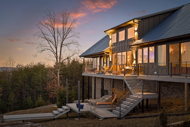 back house at dusk with a deck