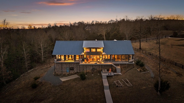 back house at dusk with a patio