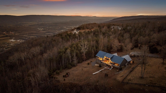 aerial view at dusk featuring a mountain view